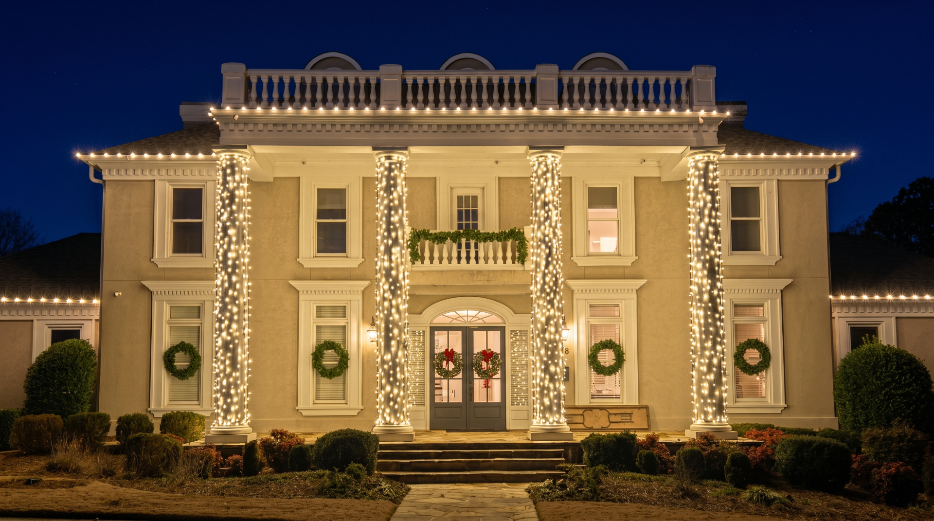 Professional holiday lighting on a luxury Atlanta home with illuminated columns